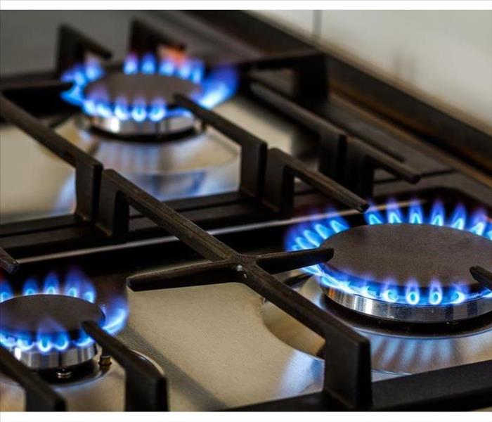 Natural gas burning on kitchen gas stove in the dark. 