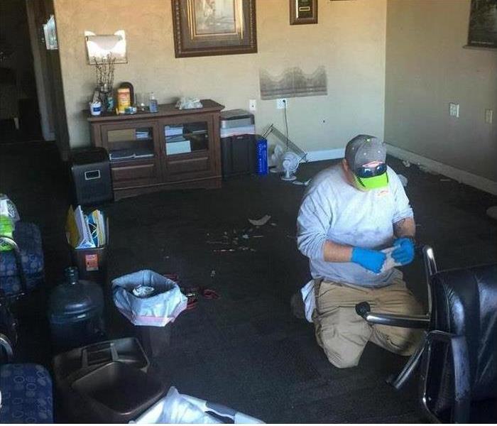 Specialist is cleaning water damage in a business